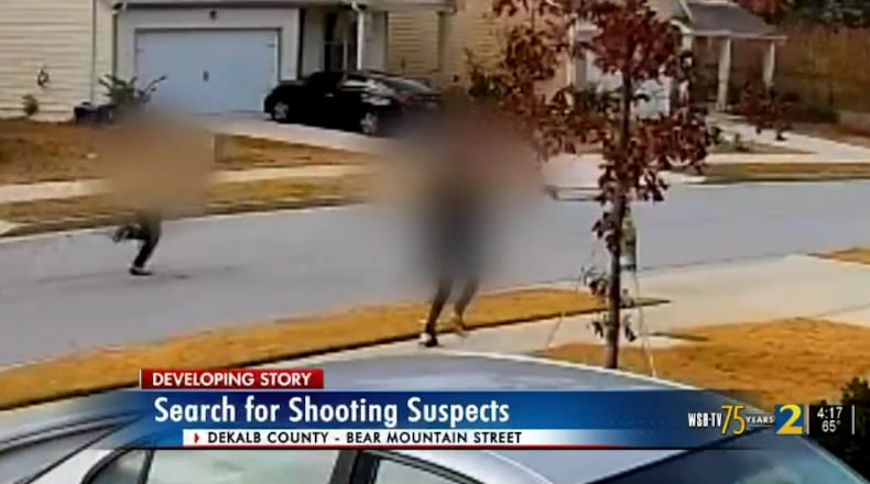 Two men were seen on video running through a neighborhood near Lithonia just moments after a fatal shooting.