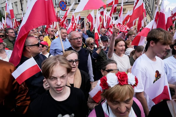 Supporters of conservative presidential candidate Karol Nawrocki take part in a march one week ahead of a decisive election in Warsaw Poland, Sunday, May 25, 2025. (AP Photo/Czarek Sokolowski)