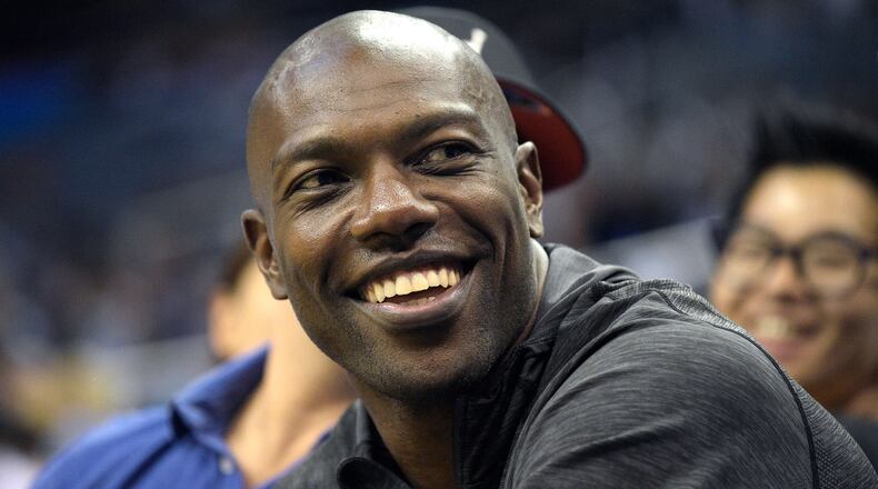 Former NFL football player Terrell Owens watches the action from court side seats during the second half of a preseason NBA basketball game between the Orlando Magic and the Memphis Grizzlies in Orlando, Fla. When Pro Football Hall of Fame voters meet the day before the Super Bowl to choose the Class of 2018, the decision to select Terrell Owens should take less than it does to microwave a bag of popcorn. T.O. belongs in Canton. It's a no-brainer.