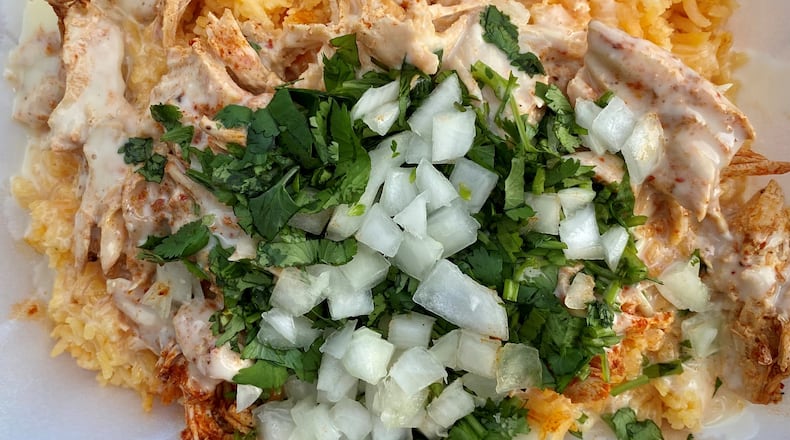 The birria rice bowl at Chef Smokeys ATL is topped with cilantro, onion and lots of queso. Wendell Brock for The Atlanta Journal-Constitution