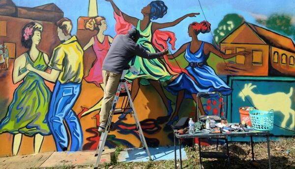 Atlanta-based muralist Corey Barksdale designs the mixed media mural at the intersection of 17th Street and Northside Drive.