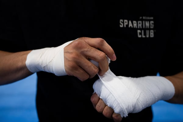 Junto Nakatani wraps his hands before a training session at a gym in Sagamihara City, Kanagawa Prefecture, Tuesday, July 1, 2025. (AP Photo/Louise Delmotte)