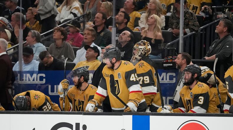 Vegas Golden Knights players watch from the bench during the third period in Game 6 of the NHL hockey Stanley Cup Final series against the Carolina Hurricanes, Sunday, June 14, 2026, in Las Vegas. (AP Photo/John Locher)