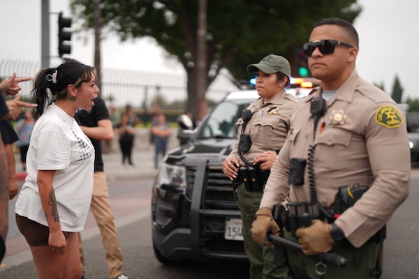 Protesters confront law enforcement agents outside an industrial park in the city of Paramount, Calif., on Saturday, June 7, 2025 (AP Photo/Eric Thayer)