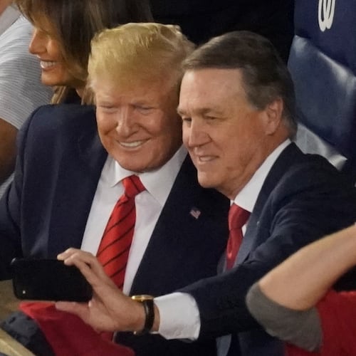 Former U.S. Sen. David Perdue, now U.S. Ambassador to China, takes a selfie with President Donald Trump during a 2019 World Series game. In his grand jury testimony, he said of Trump, "I didn’t support what he said most of the time — or a lot of the times, but I supported the agenda." (AP FILE)
