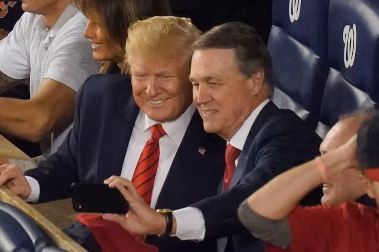 Former U.S. Sen. David Perdue, now U.S. Ambassador to China, takes a selfie with President Donald Trump during a 2019 World Series game. In his grand jury testimony, he said of Trump, "I didn’t support what he said most of the time — or a lot of the times, but I supported the agenda." (AP FILE)