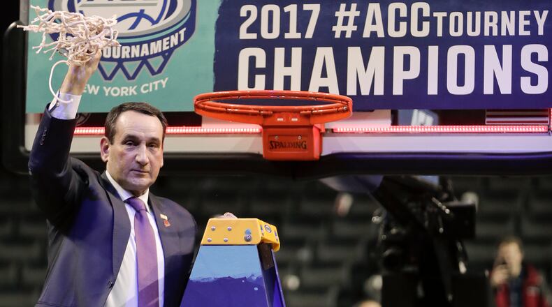 Duke Blue coach Mike Krzyzewski holds his piece of the net after Duke beat Notre Dame 75-69 in the championship game of the ACC Tournament on Saturday, March 11, 2017, in New York. (AP Photo/Julie Jacobson)