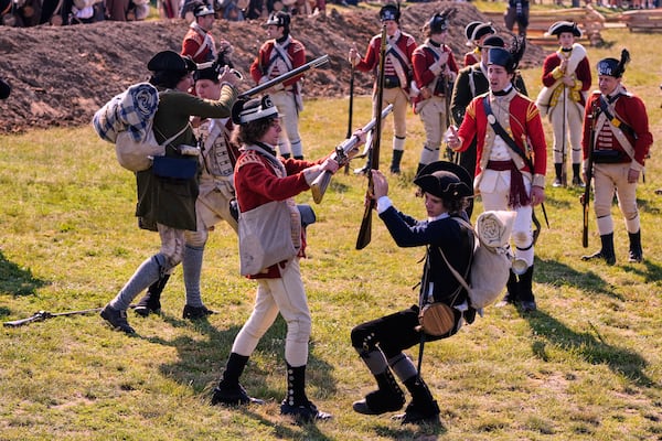British and Colonial soldiers engage during a reenactment in celebration of the 250th anniversary of the Battle of Bunker Hill, Saturday, June 21, 2025, in Gloucester, Mass. (AP Photo/Charles Krupa)