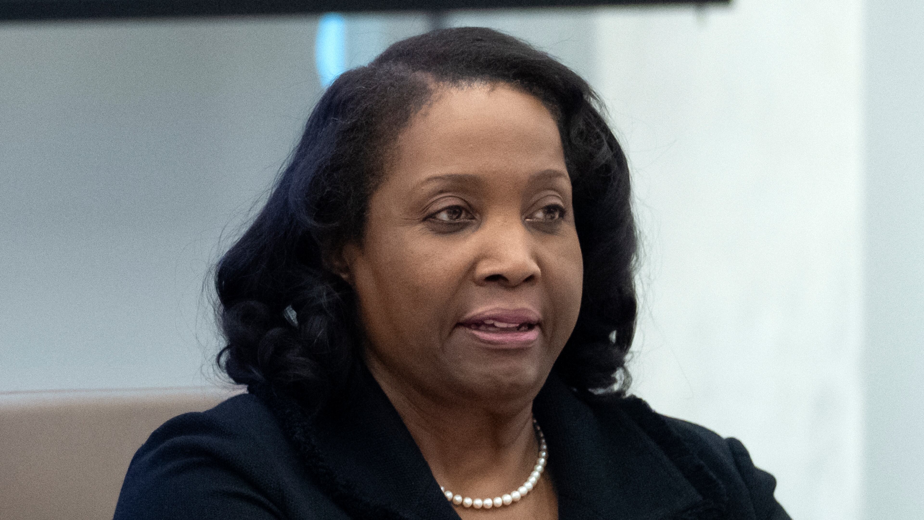 FILE - Federal Reserve Board of Governors member Lisa Cook listens during an open meeting of the Board of Governors at the Federal Reserve, June 25, 2025, in Washington. (AP Photo/Mark Schiefelbein, File)