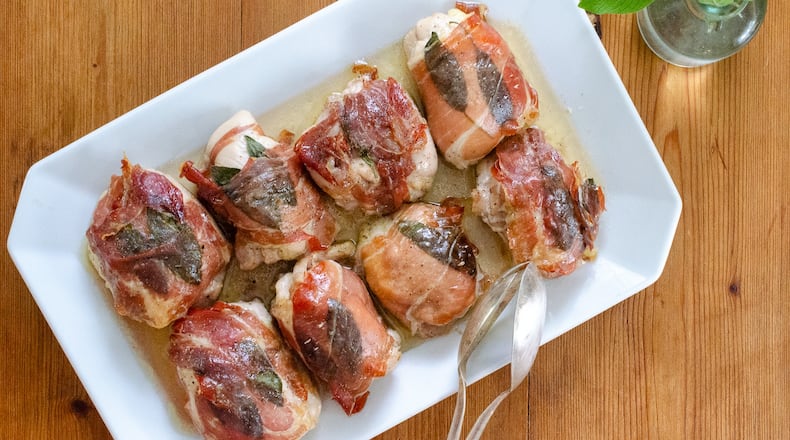 Baked chicken thighs flavored with sage and wrapped in prosciutto are a delicious, simple supper. (Virginia Willis for the AJC)