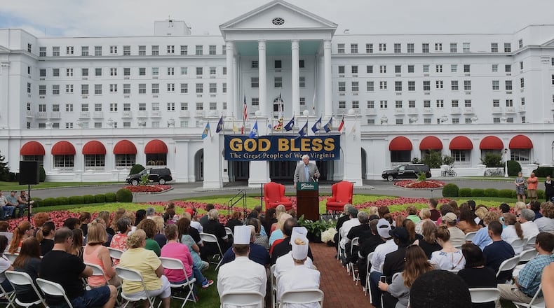 Jim Justice, owner of The Greenbrier Resort, at the podium, addresses members of Team Greenbrier and announces that the resort would open to guests next week, during a press conference in front of the hotel Thursday July 7, 2016 in White Sulphur Springs W.Va. Business would resume as usual as recovery and cleanup continues from the flood. (Rick Barbero/The Register-Herald via AP)
