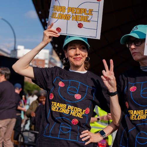 FILE - Demonstrators rally in support of transgender athletes in women's sports outside of Barclay's Center before the WNBA basketball game between the Indiana Fever and the New York Liberty, Aug. 22, 2026, in New York. (AP Photo/Angelina Katsanis, File)