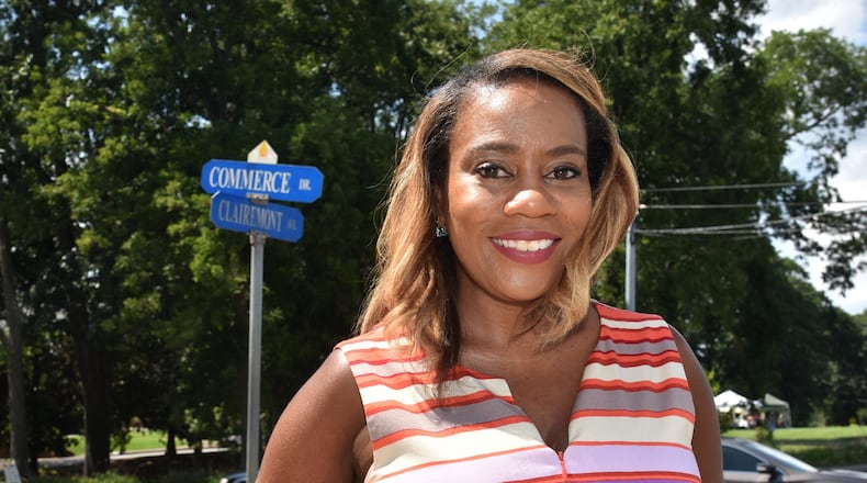 Katerina Taylor, President & CEO of the DeKalb Chamber of Commerce, at the corner of Clairemont Avenue and Commerce Drive on Wednesday, July 10, 2019. Taylor embarked on a campaign to restore its original name, Oliver Street, to what is now called Commerce Drive in downtown Decatur. The street name was changed in 1984 at the Chamber’s urging but without the input of the black residents affected by the change. HYOSUB SHIN / HYOSUB.SHIN@AJC.COM