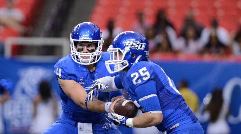 Quarterback Nick Arbuckle hands off to Kyler Neal on Saturday, Sept. 6, 2014.