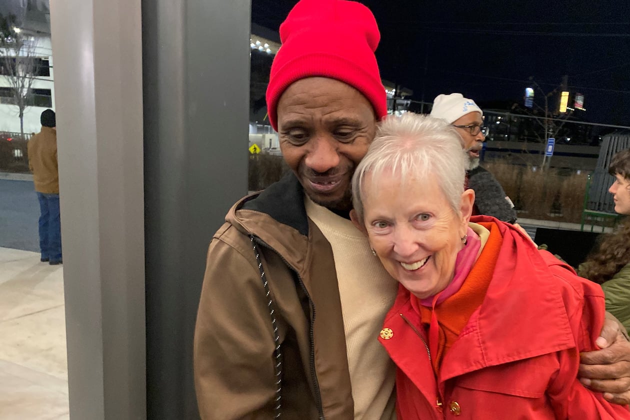 Chioke Perry, member of the Client Advisory Board to St. Joseph's Mercy Care, hugs Sister Jane Gerety, St. Joseph's Mercy Care chief mission officer, following a candlelight vigil at Mercy Care in Atlanta for 176 homeless people who died in 2024. (Ariel Hart/AJC)