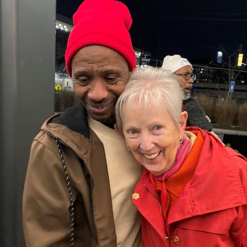 Chioke Perry, member of the Client Advisory Board to St. Joseph's Mercy Care, hugs Sister Jane Gerety, St. Joseph's Mercy Care chief mission officer, following a candlelight vigil at Mercy Care in Atlanta for 176 homeless people who died in 2024. (Ariel Hart/AJC)
