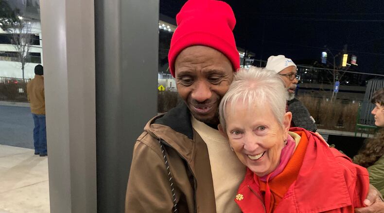 Chioke Perry, member of the Client Advisory Board to St. Joseph's Mercy Care, hugs Sister Jane Gerety, St. Joseph's Mercy Care chief mission officer, following a candlelight vigil at Mercy Care in Atlanta for 176 homeless people who died in 2024. (Ariel Hart/AJC)