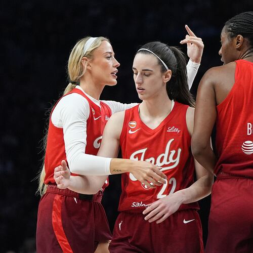 Indiana Fever guards Sophie Cunningham, left, Caitlin Clark (22) and center Aliyah Boston (7) stand on the court during the first half of a WNBA basketball game against the Minnesota Lynx, Sunday, Aug. 2, 2026, in Minneapolis. (AP Photo/Abbie Parr)