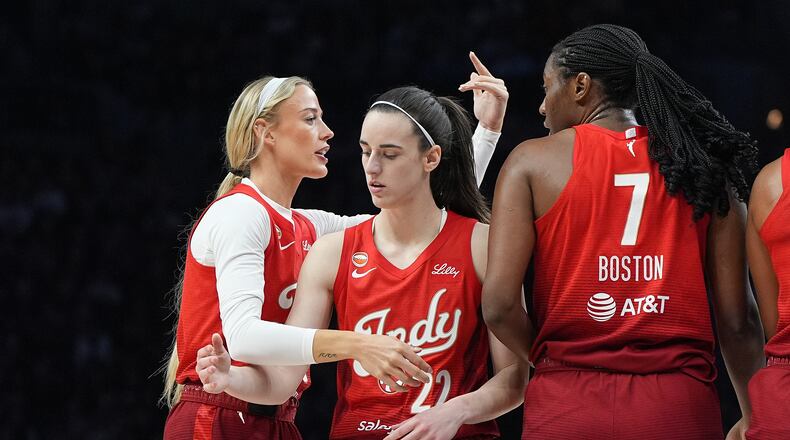 Indiana Fever guards Sophie Cunningham, left, Caitlin Clark (22) and center Aliyah Boston (7) stand on the court during the first half of a WNBA basketball game against the Minnesota Lynx, Sunday, Aug. 2, 2026, in Minneapolis. (AP Photo/Abbie Parr)