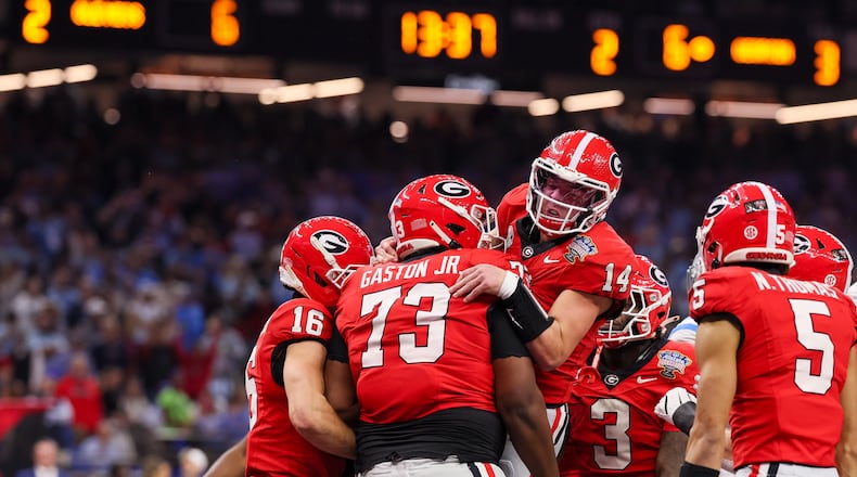 Georgia Bulldogs quarterback Gunner Stockton celebrates a 12-yard touchdown run against the Ole Miss Rebels during the second quarter of the NCAA College Football Playoff quarterfinal game at the Sugar Bowl in the Caesars Superdome, Thursday, Jan. 1, 2026, in New Orleans. (Jason Getz/AJC)