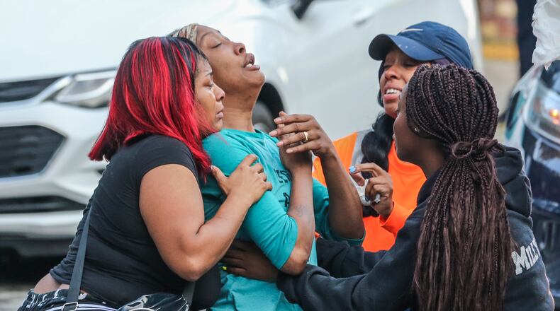 Sanmarian McClain (center-left) is comforted in her grief after losing her daughter to gunfire Thursday, Oct. 3, 2019. An 18-year old woman is dead after a stray bullet flew into her southwest Atlanta home and hit her as she slept. Gunfire erupted Thursday, in the street outside the home in the 2900 block of River Ridge Drive, according to Atlanta homicide commander Lt. Andrea Webster. Officers were sent to the residence about 6 a.m. after a woman reported her daughter had been shot and killed. When officers went inside the home, they found the victim with a gunshot wound to the chest, police said. Emergency medical officials confirmed she was dead.  Investigators learned there was an exchange between at least two shooters that may have lasted several minutes, Webster said. During that time, three stray bullets came into the house, one of which hit and killed the sleeping teen, she said.  âWe canât think of any reason she may have been the subject or the target,â Webster said.  The 18-year-old, identified by relatives as Jessica Daniels, had just graduated from South Atlanta High School in May, her mother told police.