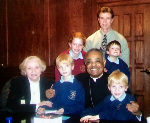 Archbishop Wilton Gregory in 2005 with AJC columnist Bill Torpy, Torpy’s mother and Torpy’s children. From left: Helen Torpy, Liam, Emma, the archbishop, Torpy, Michael and Fred. Photo by Julie Hodack