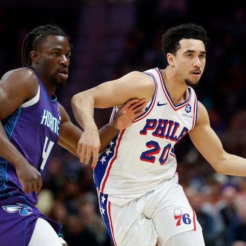 Philadelphia 76ers guard Jared McCain (20) moves the ball as Charlotte Hornets guard Sion James defends during the second half of an NBA basketball game in Charlotte, N.C., Monday, Jan. 26, 2026. (AP Photo/Nell Redmond)