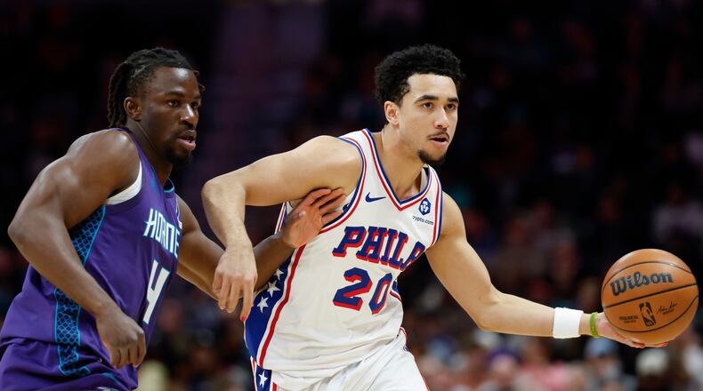 Philadelphia 76ers guard Jared McCain (20) moves the ball as Charlotte Hornets guard Sion James defends during the second half of an NBA basketball game in Charlotte, N.C., Monday, Jan. 26, 2026. (AP Photo/Nell Redmond)