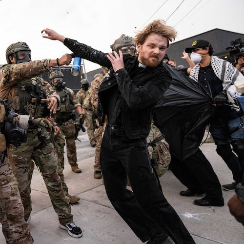 FILE - A federal immigration enforcement agent sprays Rev. David Black, of the First Presbyterian Church of Chicago, as he demonstrates outside the U.S. Immigration and Customs Enforcement facility in Broadview, Ill, on Sept. 19, 2025. (Ashlee Rezin/Chicago Sun-Times via AP, File)