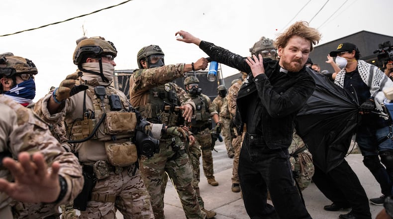 FILE - A federal immigration enforcement agent sprays Rev. David Black, of the First Presbyterian Church of Chicago, as he demonstrates outside the U.S. Immigration and Customs Enforcement facility in Broadview, Ill, on Sept. 19, 2025. (Ashlee Rezin/Chicago Sun-Times via AP, File)