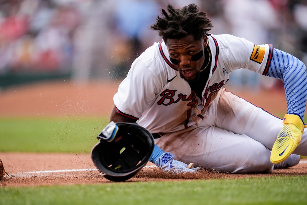 Braves outfielder Ronald Acua Jr. slides past third base in the sixth inning of Sunday's loss to the Rockies.
