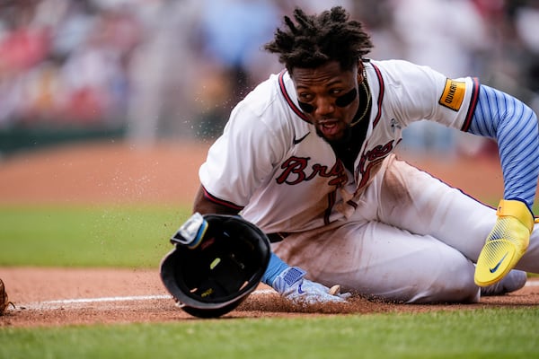 Braves outfielder Ronald Acuña Jr. slides past third base in the sixth inning of Sunday's loss to the Rockies.