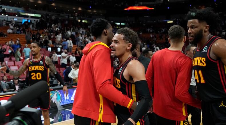 Hawks guard Trae Young, center left, and forward Saddiq Bey (41) celebrate with teammates after the Hawks defeated the Miami Heat in an NBA basketball play-in tournament game Tuesday, April 11, 2023, in Miami. (AP Photo/Rebecca Blackwell)
