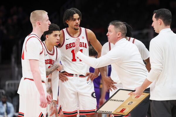 Georgia head coach Mike White, right, talks with Georgia guard Blue Cain (0), Georgia guard Dakota Leffew (1), and Georgia forward Asa Newell (14) during the second half against Grand Canyon in the Holiday Hoopsgiving tournament at State Farm Arena, Saturday, December 14, 2024, in Atlanta. Georgia won 73-68. (Jason Getz / AJC)
