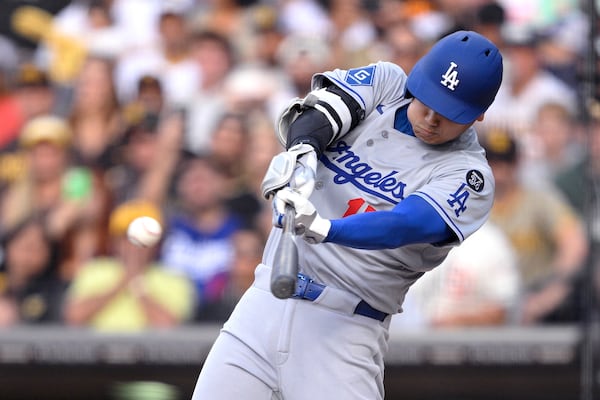 Los Angeles Dodgers' Shohei Ohtani (17) hits a double against the San Diego Padres during the first inning of a baseball game Monday, June 9, 2025, in San Diego. (AP Photo/Orlando Ramirez)