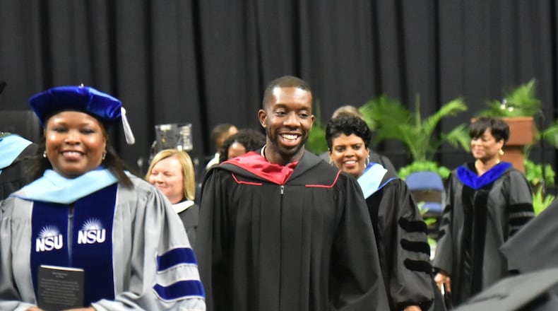 Everton Blair (center) attended Shiloh High School's 2019 graduation ceremony. Blair is a graduate of the school and recently completed a term on the Gwinnett school board. (Hyosub Shin / Hyosub.Shin@ajc.com)
