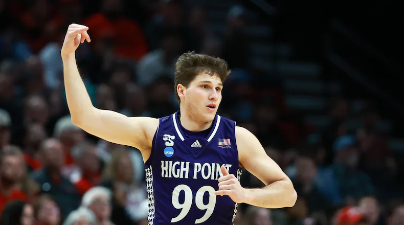 High Point guard Chase Johnston reacts after shooting a 3-pointer during the first half in the first round of the NCAA college basketball tournament against Wisconsin, Thursday, March 19, 2026, in Portland, Ore. (AP Photo/Craig Mitchelldyer)
