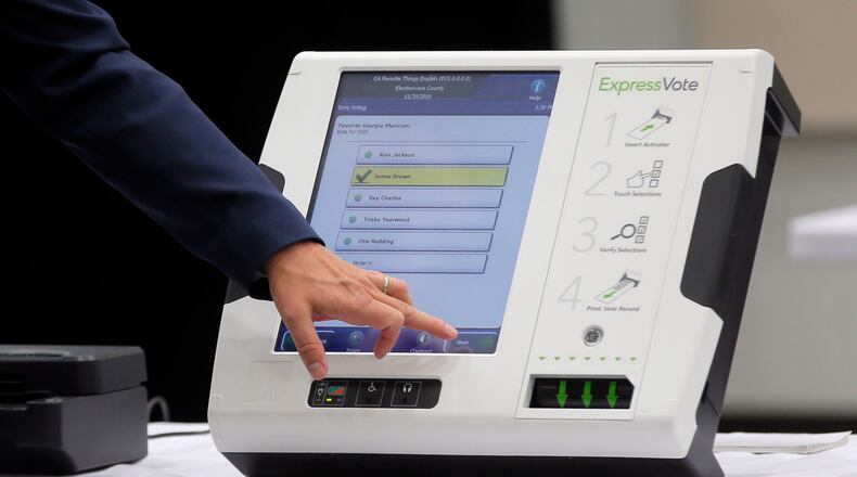A voting machine displayed this summer at a meeting of a commission named by Secretary of State Brian Kemp. BOB ANDRES /BANDRES@AJC.COM
