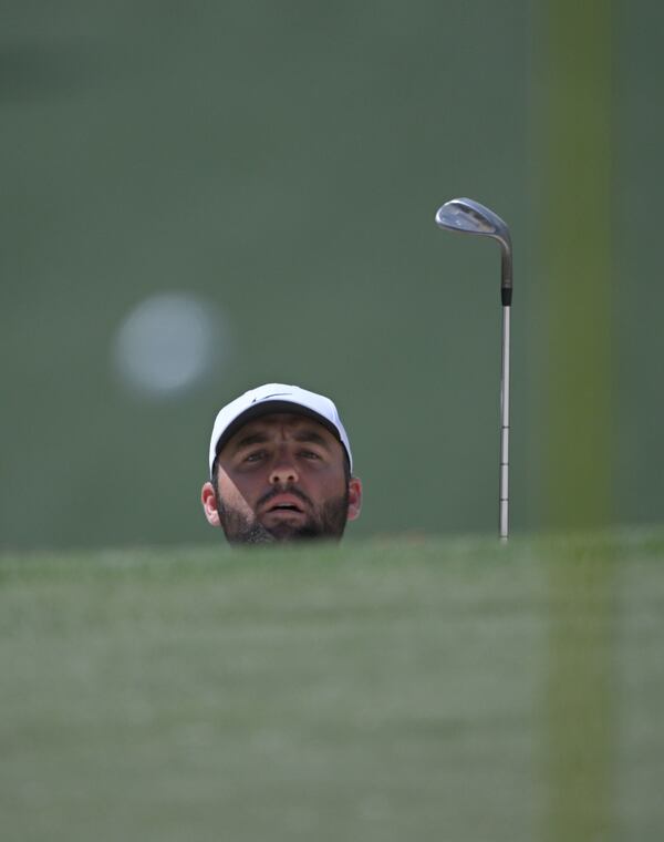 Scottie Scheffler watches his the flight of his ball ont he 7th green at the 2024 Masters Tournament at Augusta National Golf Club, Thursday, April 11, 2024, in Augusta, Ga. (Hyosub Shin / Hyosub.Shin@ajc.com)

