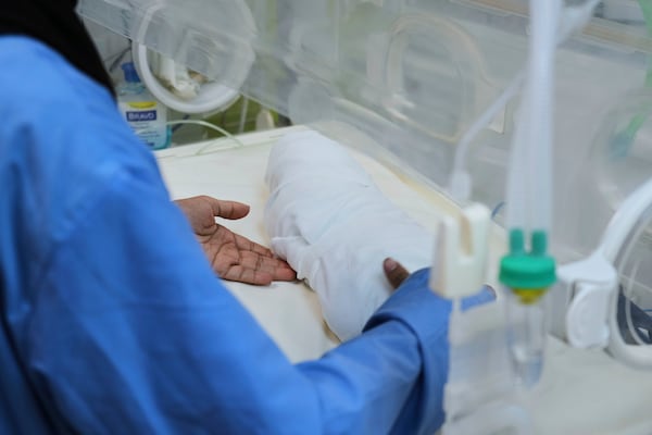 A nurse carries the body of a 15-days-old premature infant Sila Zidane after she died at Nasser Hospital in Khan Younis, Gaza, on Wednesday, April 23, 2025. (AP Photo/Abdel Kareem Hana)
