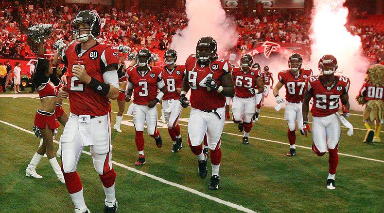 Matt Ryan leads the offense onto the field for his NFL debut Sunday, Sept. 7, 2008, at the Georgia Dome against the Detroit Lions. ( Curtis Compton/ AJC)