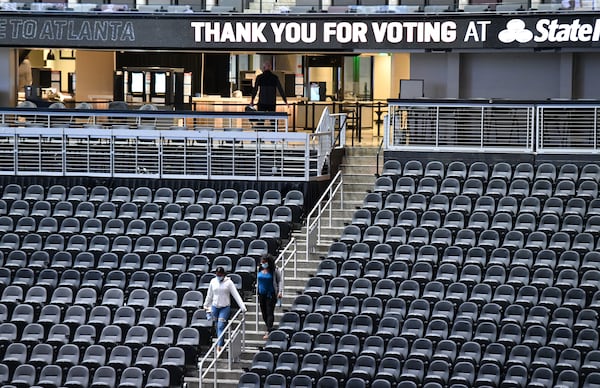 Fulton County residents walk down to cast their ballots on the floor of State Farm Arena in Atlanta on Wednesday, October 28, 2020. (Hyosub Shin / Hyosub.Shin@ajc.com)
