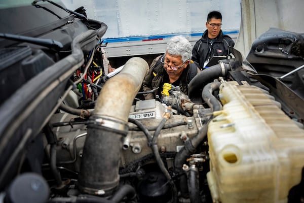 A student studies a truck engine at the Driving Academy on Tuesday, June 10, 2025 in Linden, N.J., where students prepare to obtain a Commercial Driver’s License (CDL) with multilingual instructors. (AP Photo/Angelina Katsanis)