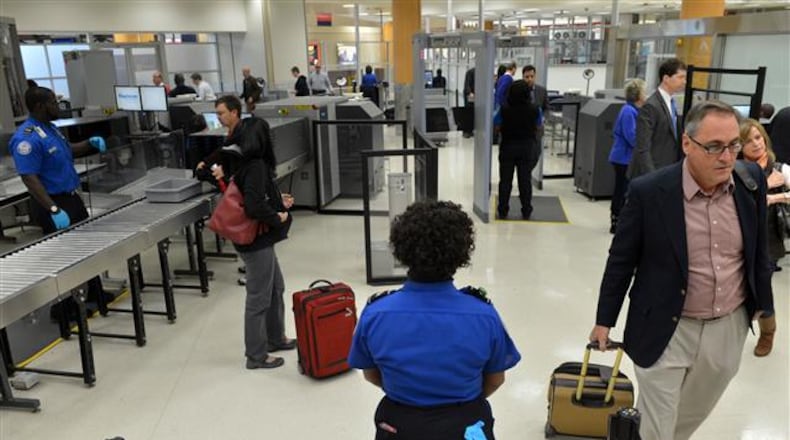 JANUARY 15, 2014 ATLANTA TSA agents man the checkpoint for pre-cleared passengers Wednesday. The Transportation Security Administration (TSA) officially opened an application site at Hartsfield-Jackson Atlanta International Airport (ATL) Wednesday, January 15, 2014, for TSA Pre (TM), an expedited screening program that allows travelers to leave on their shoes, light outerwear and belt, keep their laptop in its case and keep 3-1-1 compliant liquids/gels bag in a carry-on bag. U.S. citizens and lawful permanent residents will now be able to go through a pre-enrollment process online at www.TSA.gov, make an appointment and complete their enrollment at the application center at gate A19 to verify their identity and provide documentation to confirm their citizenship/immigration status as well as to provide fingerprints. TSA is currently in the process of expanding to more than 300 application centers across the country. The application center at Hartsfield-Jackson Atlanta International Airport is one of the first centers to open in the southeast. KENT D. JOHNSON / KDJOHNSON@AJC.COM