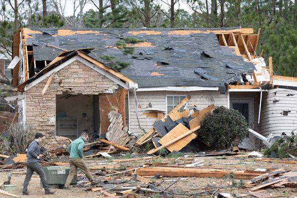 National Weather Service employees survey the tornado damage homes in the Lexington Park neighborhood in LaGrange Friday, Jan 13, 2023.   (Steve Schaefer/steve.schaefer@ajc.com)