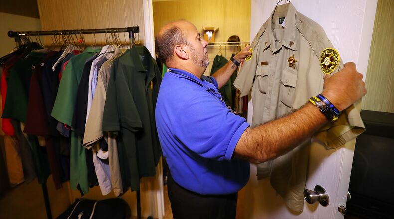 Hanging it up after 31 years, Putnam County Deputy Sgt. John Harper gathers the police uniforms from the closet of his home preparing to turn them in at week's end on Wednesday, Nov. 17, 2021, in Hillsboro. Harper had a sudden epiphany recently that it was time to go, in part because of the current climate involving law enforcement. Once he made his decision, he was ready to go immediately. (Curtis Compton / Curtis.Compton@ajc.com)