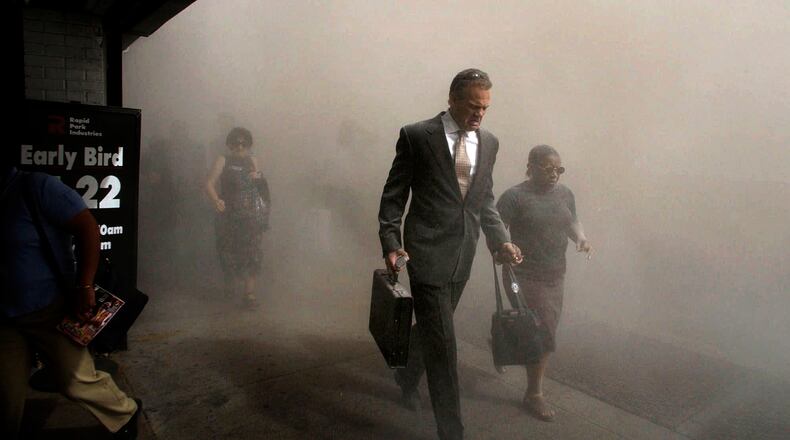 FILE - Pedestrians flee the area of New York's World Trade Center in lower Manhattan on Tuesday, Sept. 11, 2001. (AP Photo/Amy Sancetta, FIle)
