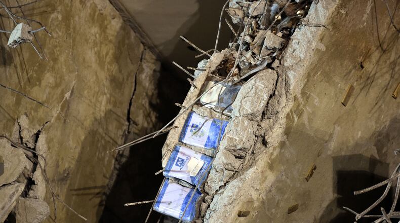 TOPSHOT - Blue paint cans, seen sandwiched in between a layer of concrete, is seen at the Wei-Kuan complex which collapsed in the 6.4 magnitude earthquake, in the southern Taiwanese city of Tainan on February 8, 2016. Four survivors on February 8 were pulled alive from the rubble of an apartment complex felled by an earthquake in Taiwan, as questions intensified over why the building collapsed. Images from the site showed metal cans and foam used inside the concrete framework of the building, raising questions over the safety of the construction. AFP PHOTO / Sam Yeh / AFP / SAM YEH (Photo credit should read SAM YEH/AFP/Getty Images)