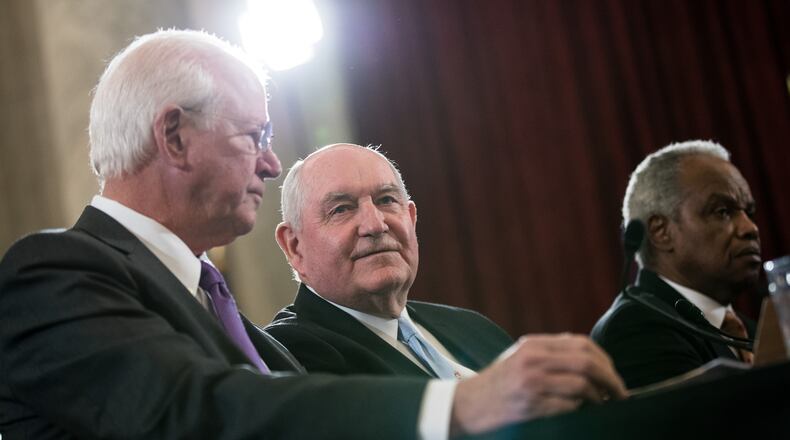 Former Georgia Gov. Sonny Perdue, center, has gained a lot of attention recently in his role as secretary of agriculture. (Photo by Drew Angerer/Getty Images)