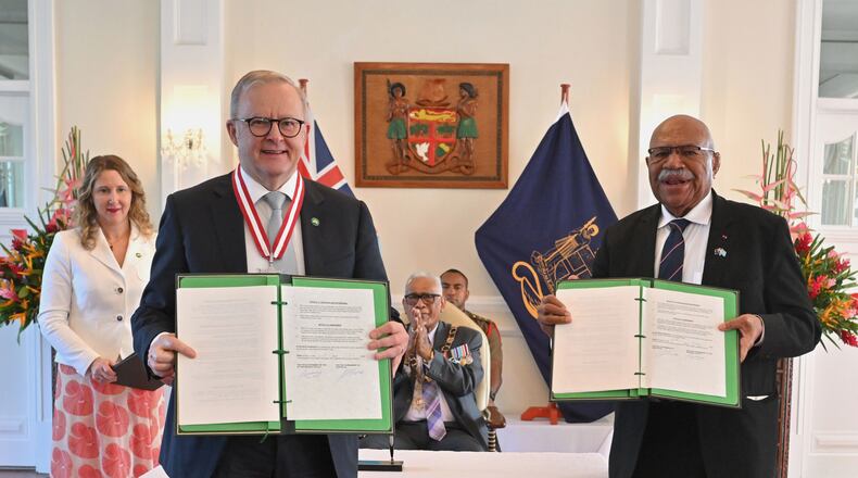 Australia's Prime Minister Anthony Albanese, left, and Fiji's Prime Minister Sitiveni Rabuka display a new bilateral defense alliance they have just signed at State House in Suva, Fiji, Monday, July 6, 2026. (Mick Tsikas/AAP Image via AP)